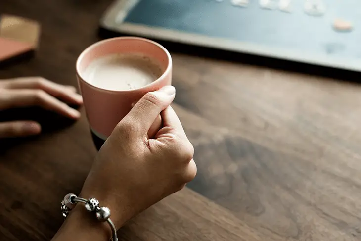 holding a cup of milk tea