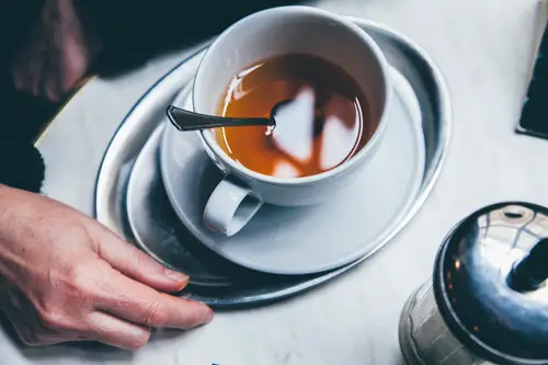 Black tea served in a blue cup and saucer