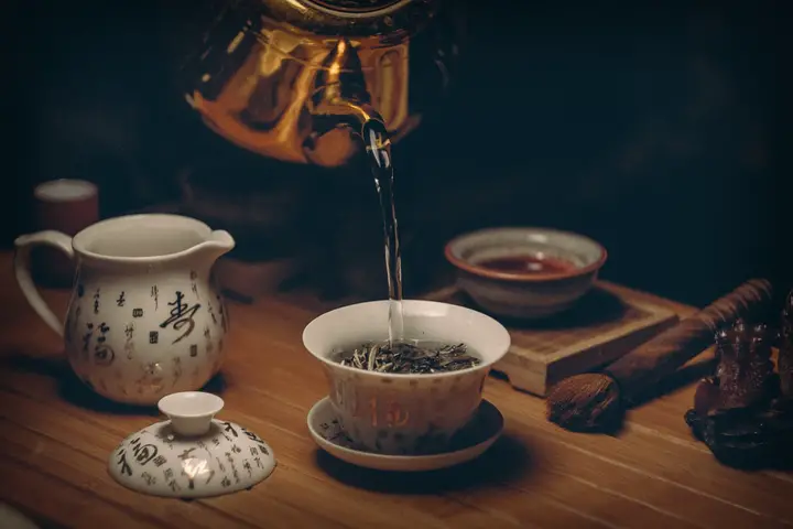 pouring water into tea cup