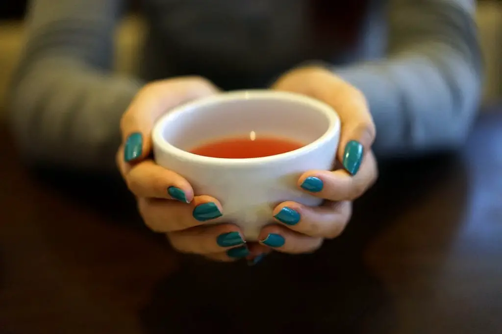 girl holding a tea cup