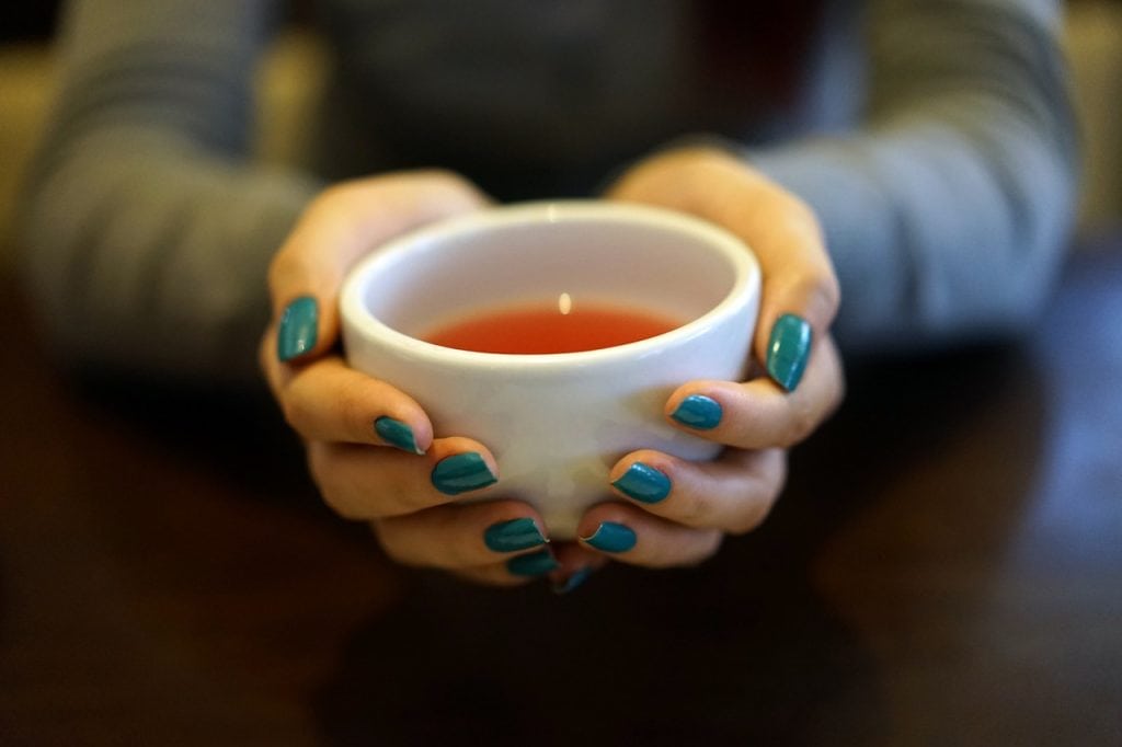 girl holding a tea cup