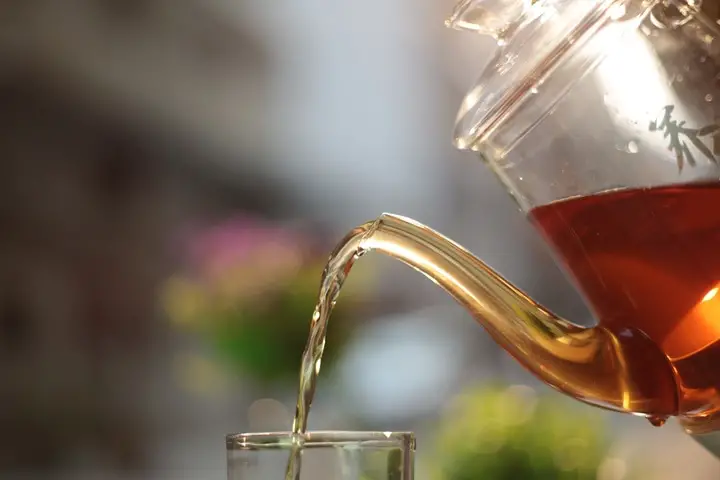 pouring a cup of organic black tea