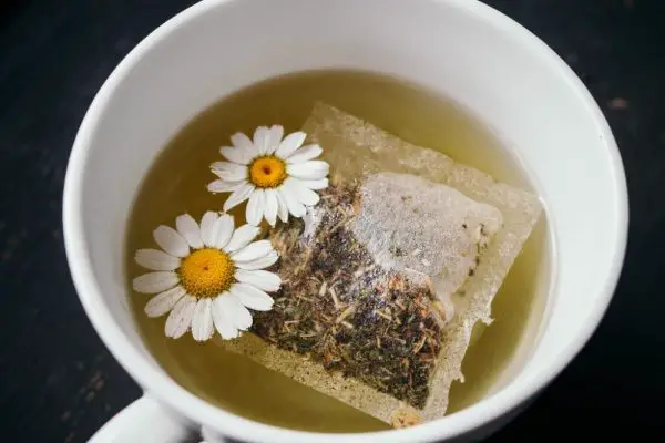 Chamomile tea bag and flowers