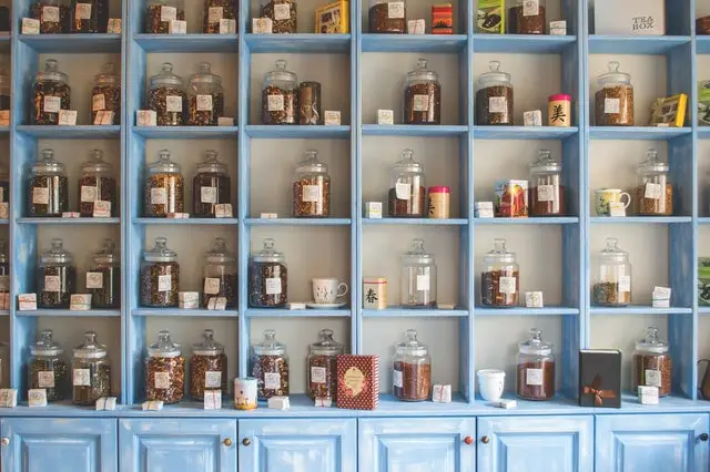 jars of tea on a shelf cabinet