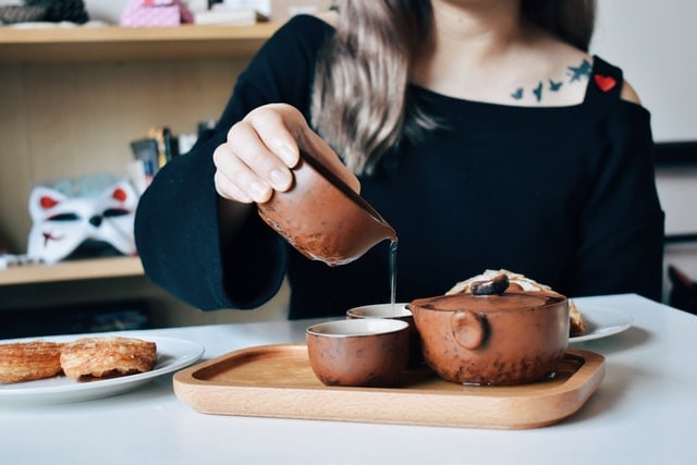 Woman Pouring Hot Tea