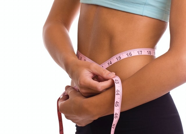 Woman Measuring Waist With Tape