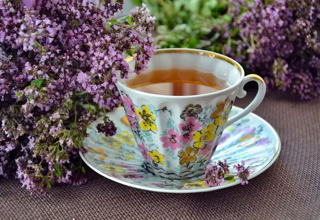 white pink and yellow ceramic mug and saucer