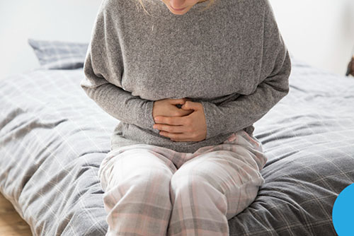 sick lady holding her stomach