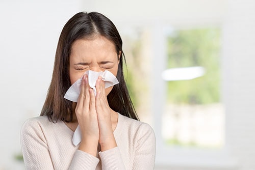 young woman suffering from an allergy