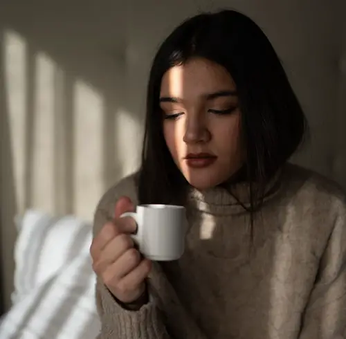 Young Girl Drinking Tea On bed