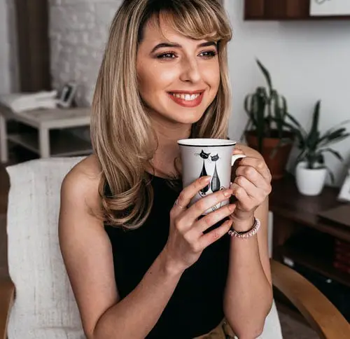Young Lady Smiling With Cup Of Tea