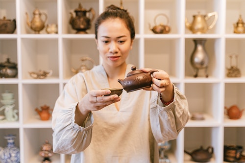 Young Woman Pouring Tea