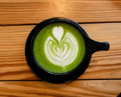 Latte on black ceramic mug