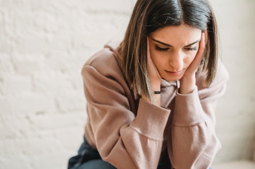 Sad woman sitting in the room