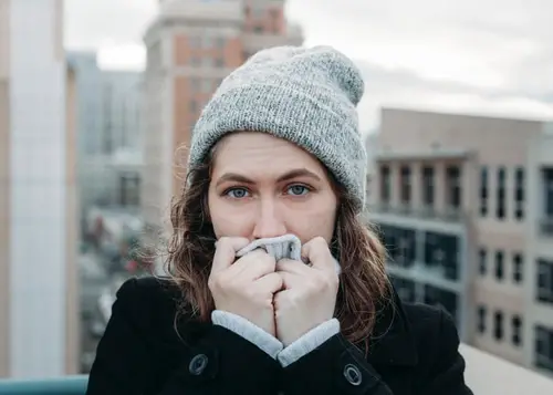 Woman shivering in the cold