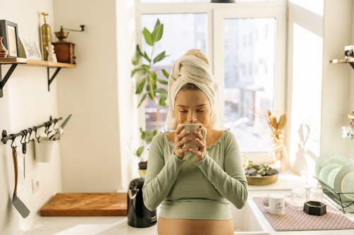 Woman smelling her cup of hot tea