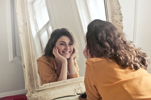 Woman smiling at the mirror