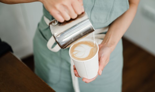 Latte art by a coffee maker at a cafe